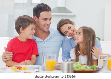 Cute Family During The Dinner At The Table At Home