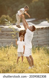 Cute Family Playing In A Summer Field