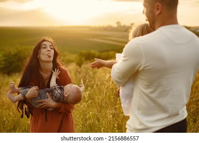 Cute Family Playing In A Summer Field