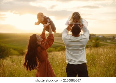 Cute Family Playing In A Summer Field