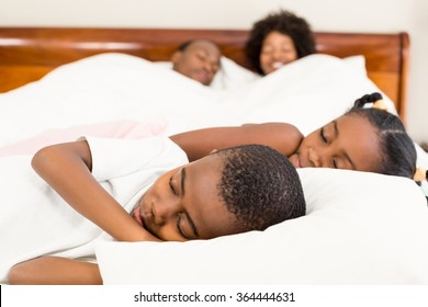 Cute family sleeping in the bedroom