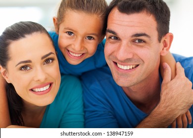 Cute Family Of Three Face Closeup Portrait At Home