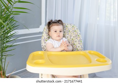 Cute Fat Baby Girl Sitting In A High Chair At An Empty Table And Waiting For Food, Baby Food Concept