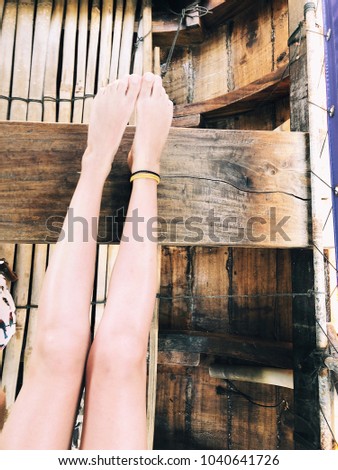 Cute feet with decoration in wooden boat. Travel inspiration