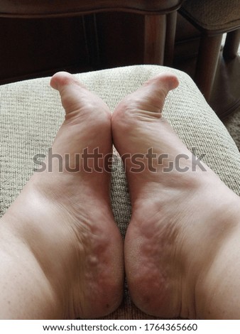 Cute feet up on an ottoman 