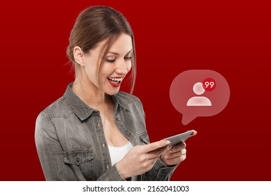 Cute female blogger with red lipstick, matching with color of background, surprised and happy with new followers, notification with number of subscribers popping up from screen. Social media concept