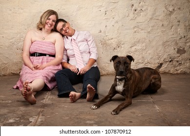 Cute female friends with pet dog in basement - Powered by Shutterstock