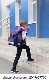 A Cute First Grader Boy In A School Uniform With A Schoolbag Goes To School On A Sunny Autumn Day. Celebration On September 1st. Knowledge Day. Selective Focus