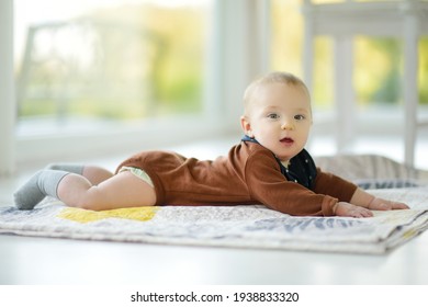 Cute Five Months Old Baby Boy Lying On His Tummy. Baby During Tummy Time. Cute Little Child Learning To Crawl.