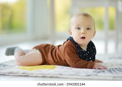 Cute Five Months Old Baby Boy Lying On His Tummy. Baby During Tummy Time. Adorable Little Child Learning To Crawl.