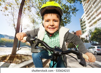 Cute Five Years Old Boy Riding His Bike In Town