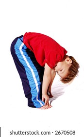 A Cute Four Year Old Boy Wearing Red And Blue Who Is Bending Over And Touching His Toes.