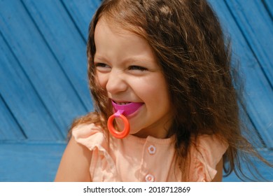 A cute four-year-old girl with a vestibular hard mouthguard plate for correcting the bite of teeth in orthodontics. Children's orthodontic mouthguard. myofunctional trainer. mouth breathing habit