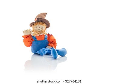 Cute And Friendly Scarecrow Doll In Overalls