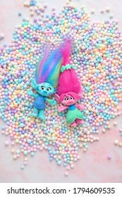 cute friends trolls with gentle colorful balls decor on pink background. Harper Pinsel and Queen Poppy - modern toy hasbro trolls. concept of children's games, fun, toys, friendship. top view