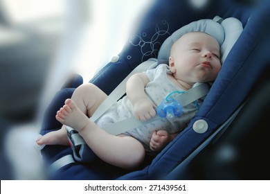 Cute Funny Baby Boy Is Sleeping In Car ?hild Safety Seat, Image With Toning, Blur Background And Effect Of Soft Shining Sun