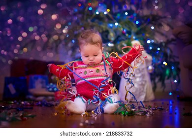 Cute Funny Baby Girl Sitting Under Christmas Tree