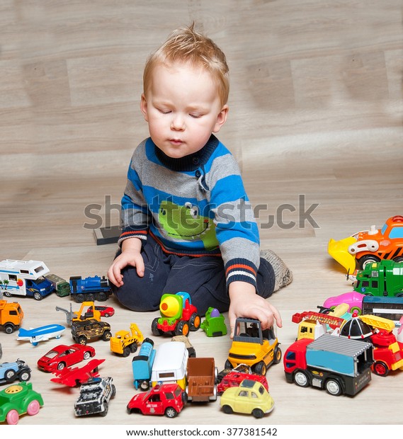 Cute funny Boy with toy cars\

