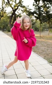 Cute Funny Child Girl 4-5 Year Old Wear Bright Pink Sweater Having Fun Playing In Park Outdoor. Childhood. Autumn Season. 