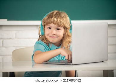 Cute Funny Child Using Laptop Computer, Kid Boy Studying Through Online E-learning. Little Funny System Administrator.