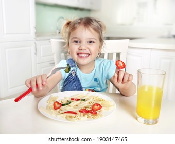 Cute Funny Cuacasian Kid Eating Noodles.Little Girl Have A Meal.Happy Preschooler Lifestyle Portrait.