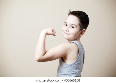 cute funny kid flexing biceps - Powered by Shutterstock