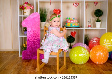 Cute Funny Little Child In First Birthday With Colored Balloons In The Bright Room