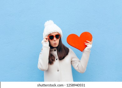 Cute Funny In Love Girl Holding Big Heart On Blue Background. Surprised Romantic Girl Having A Crush On Valentine
