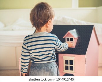 A Cute Gender Confident Little Boy Is Busting Stereotypes And Socially Imposed Expectations By Playing With A Big Pink Doll House And Having A Great Time