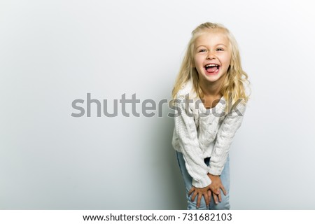Cute girl 4-5 year old posing in studio