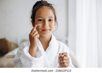 Cute Girl Applying Face Cream