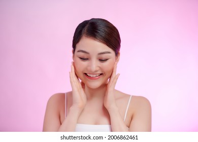 Cute girl with big eyes looking at camera and holding hands near face,  - Shutterstock ID 2006862461