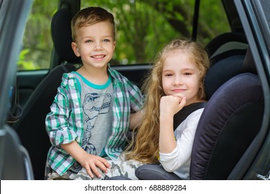 Cute Girl And Boy Sitting In Car Back Seat 