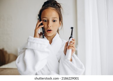 Cute Girl Brushing Teeth And Using Phone