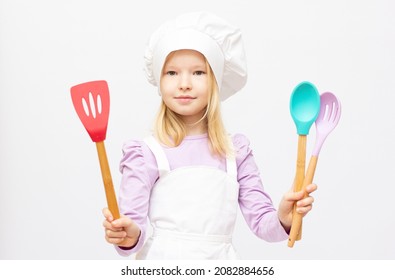 Cute Girl In Chef Hat With Spatula And Skimmer, Isolated On White