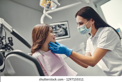 Cute girl in dental clinic. Child in stomatological cabinet with female dentist.