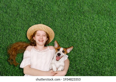 Cute girl and dog enjoy spring day on the grass in the park. Spring, Easter background.