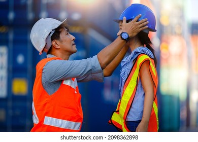 Cute girl dreams of becoming an engineer. A middle-aged male engineer wears a safety suit to his daughter with love and care. Promoting children's learning, imagination and cognitive development. - Powered by Shutterstock