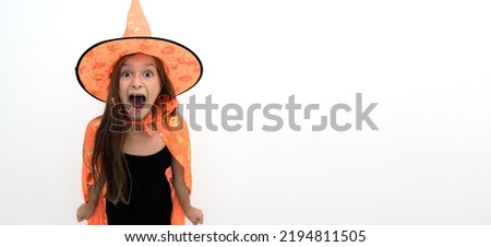 a cute girl dressed in a witch costume for Halloween screams while looking at the camera, isolated on a white background. portrait of a Witch for Halloween, discounts and sales for Halloween. 