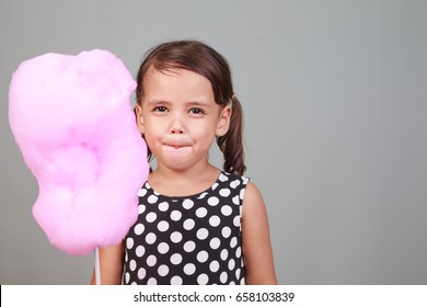 Cute Girl Eating Cotton Candy.