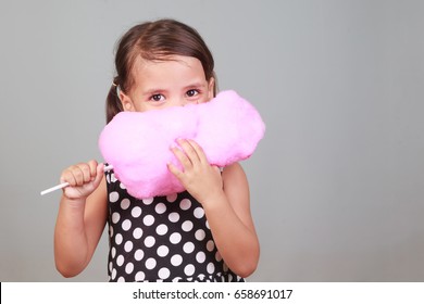 Cute Girl Eating Cotton Candy.