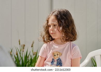 Cute Girl Eating Pita In The Backyard