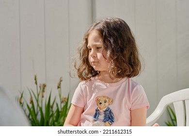 Cute Girl Eating Pita In The Backyard