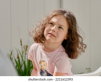 Cute Girl Eating Pita In The Backyard