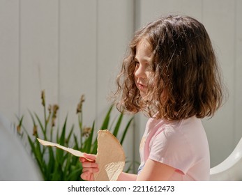 Cute Girl Eating Pita In The Backyard