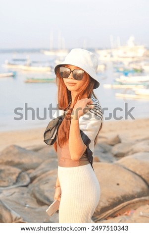 Similar – Young surfer woman with top and bikini kissing surfboard