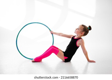 Cute girl gymnast with hoop