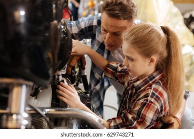 Cute Girl And Her Dad Fixing Bike Together