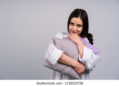 Cute Girl In Home Clothes And Hugging My Pillow Smiling, Dark Hair In A Braid, The Concept Of Comfort And Home.