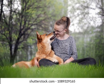 Cute girl with huge scary dog. Nature, green grass, summer